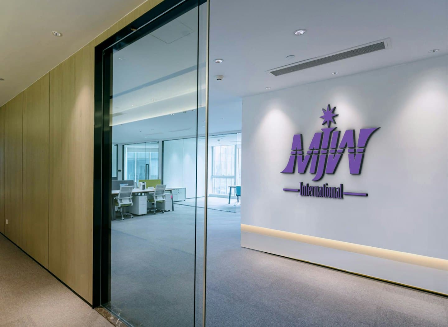 A purple 3D logo hangs on a modern office wall.
